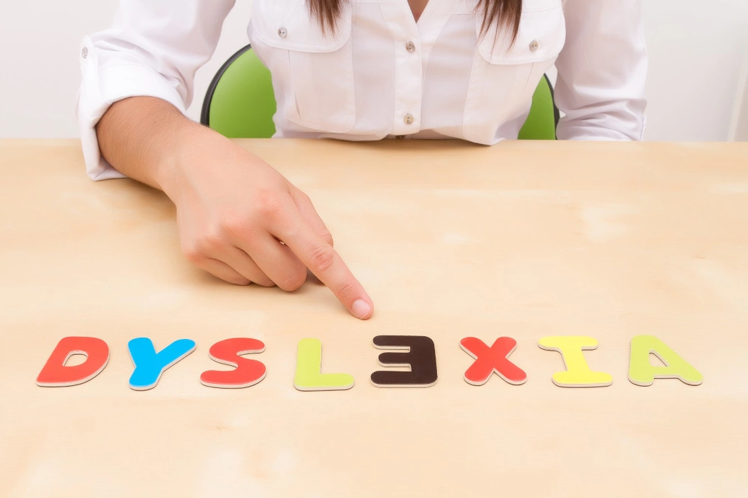 a child playing with alphabet letters spelling out dyslexia